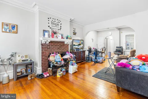 a living room with furniture and a pool table