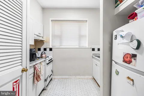 a kitchen with a refrigerator and a stove