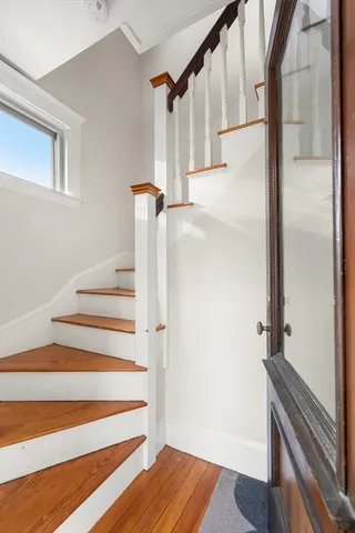 a view of entryway and hall with wooden floor