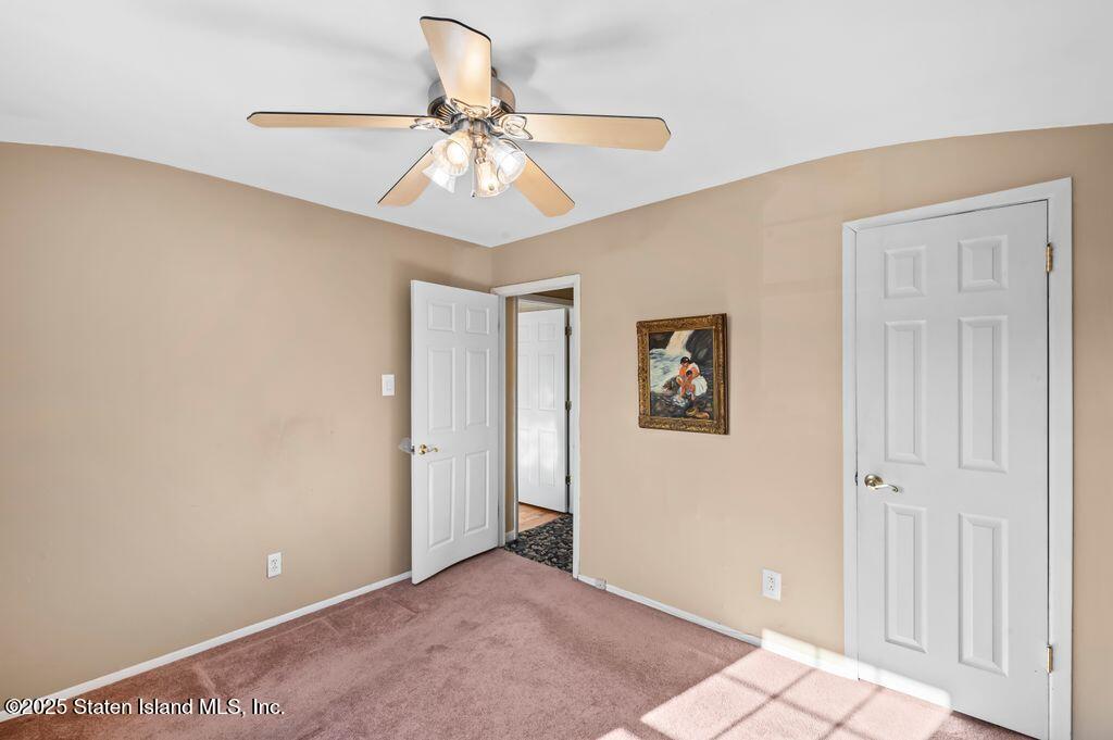 53 Plymouth Road Staten Island, NY 10314 - Photo 15 of 23 a view of a hallway with a chandelier fan