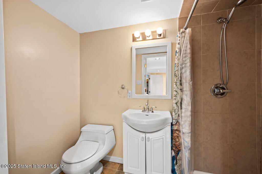 53 Plymouth Road Staten Island, NY 10314 - Photo 20 of 23 a bathroom with a toilet sink and mirror