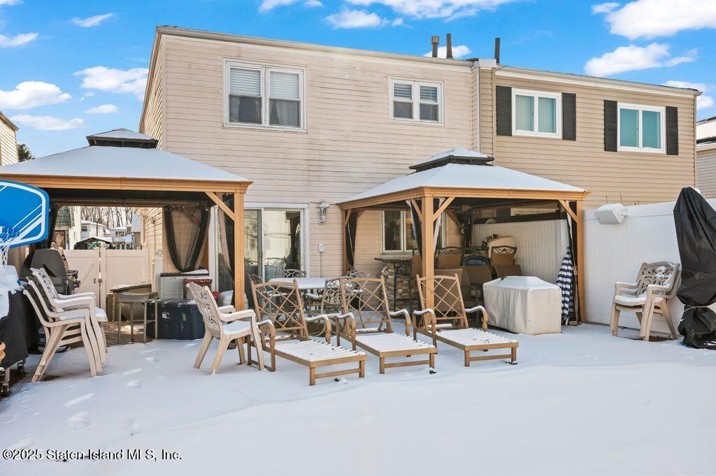 53 Plymouth Road Staten Island, NY 10314 - Photo 21 of 23 a view of a patio with dining table and chairs and a barbeque