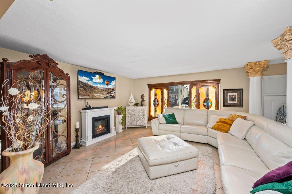 53 Plymouth Road Staten Island, NY 10314 - Photo 4 of 23 a living room with furniture and a fireplace
