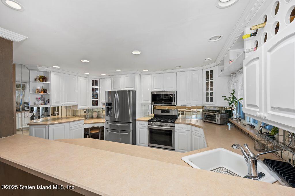 53 Plymouth Road Staten Island, NY 10314 - Photo 10 of 23 a kitchen with stainless steel appliances granite countertop a refrigerator sink and stove