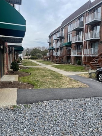 a front view of a building with a yard