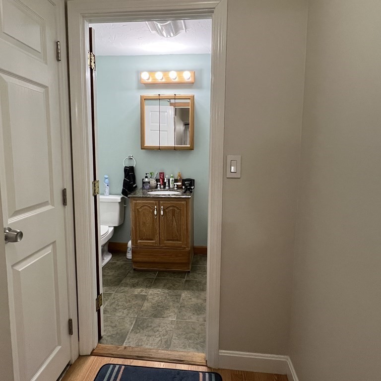 1186 Worcester Road, Unit 611 Framingham, MA 01702 - Photo 11 of 14 a bathroom with a sink a mirror and a toilet