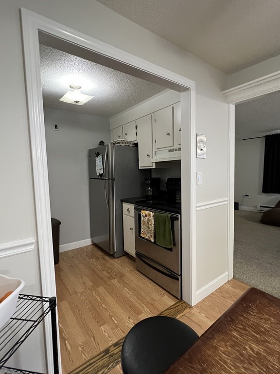 1186 Worcester Road, Unit 611 Framingham, MA 01702 - Photo 13 of 14 a kitchen with stainless steel appliances kitchen island granite countertop a refrigerator and a sink
