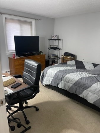 1186 Worcester Road, Unit 611 Framingham, MA 01702 - Photo 14 of 14 a bedroom with two beds and a laptop on desk
