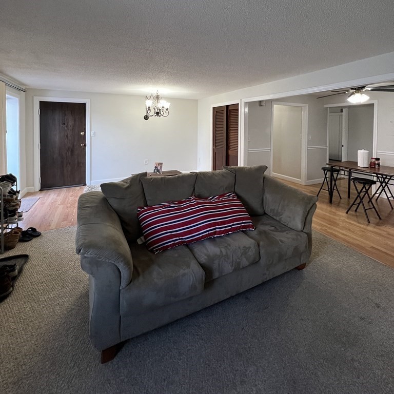 1186 Worcester Road, Unit 611 Framingham, MA 01702 - Photo 2 of 14 a bedroom with furniture and a lamp