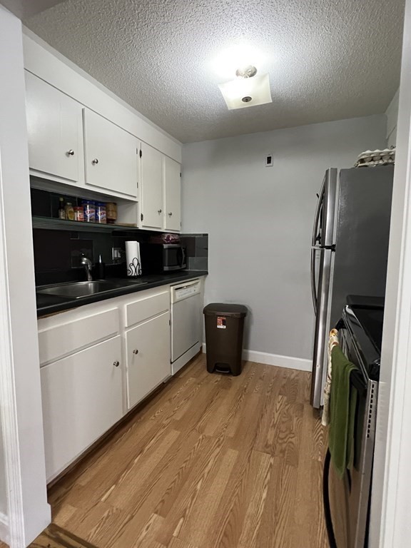 1186 Worcester Road, Unit 611 Framingham, MA 01702 - Photo 5 of 14 a kitchen with stainless steel appliances a refrigerator sink and cabinets