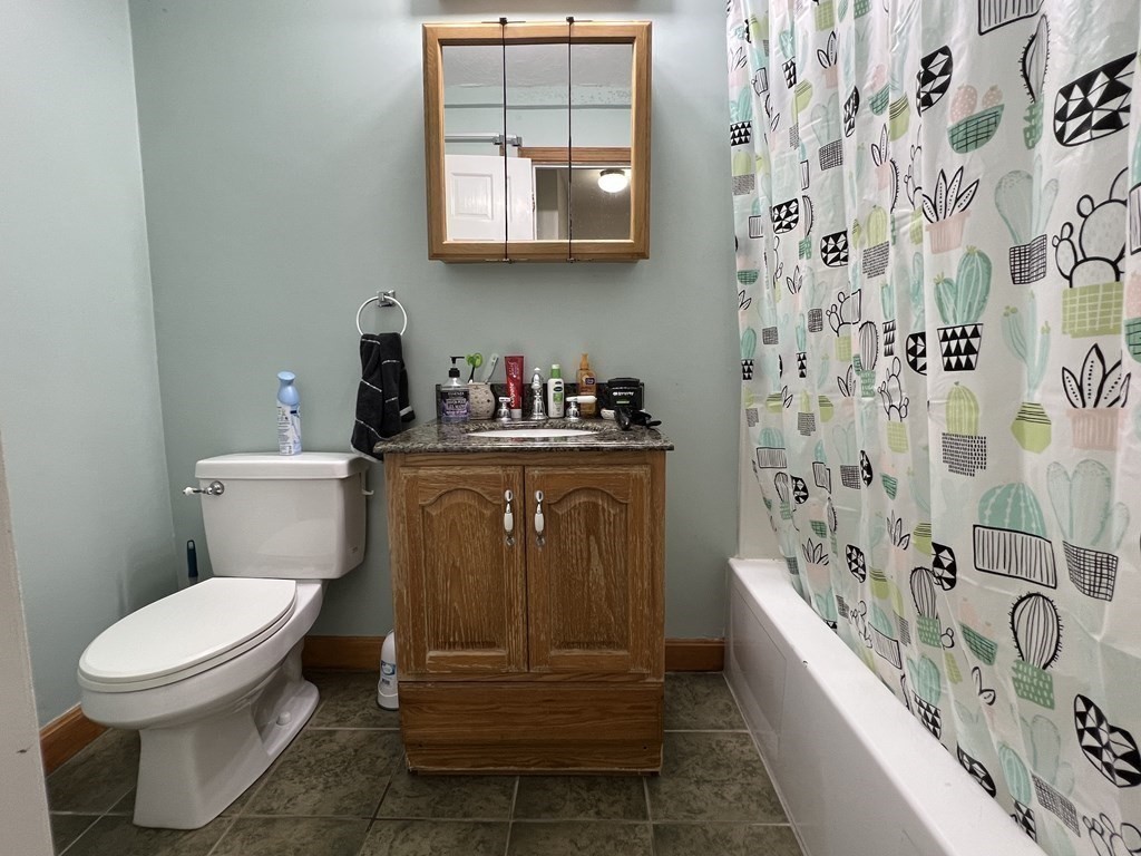 1186 Worcester Road, Unit 611 Framingham, MA 01702 - Photo 8 of 14 a bathroom with a sink a toilet and bathtub