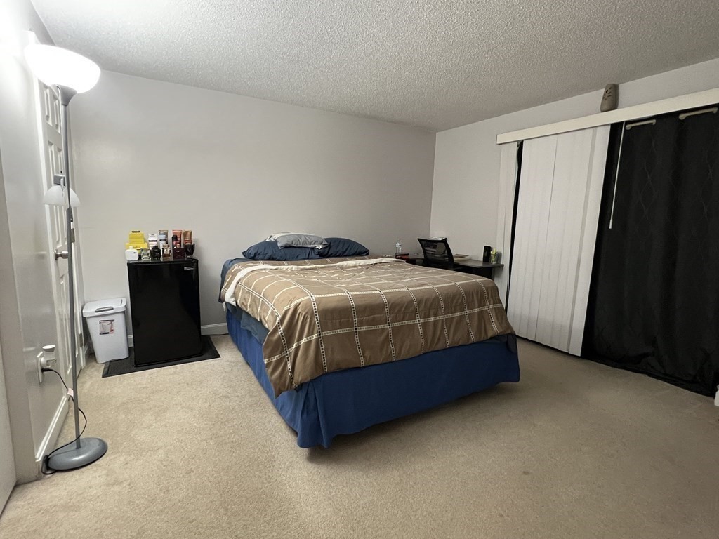 1186 Worcester Road, Unit 611 Framingham, MA 01702 - Photo 9 of 14 a bedroom with a bed and walk in closet