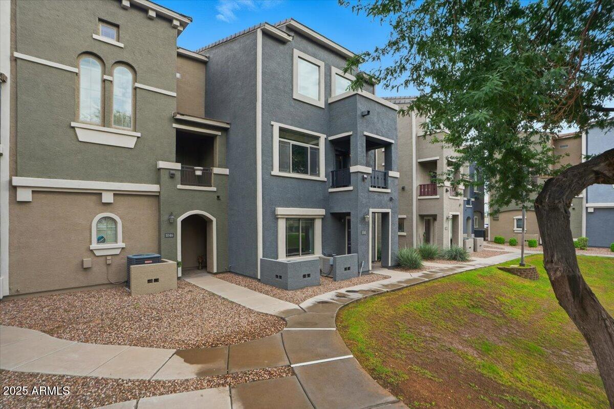 2401 East Rio Salado Parkway, Unit 1045 Tempe, AZ 85288 - Photo 1 of 41 a front view of a house with a yard