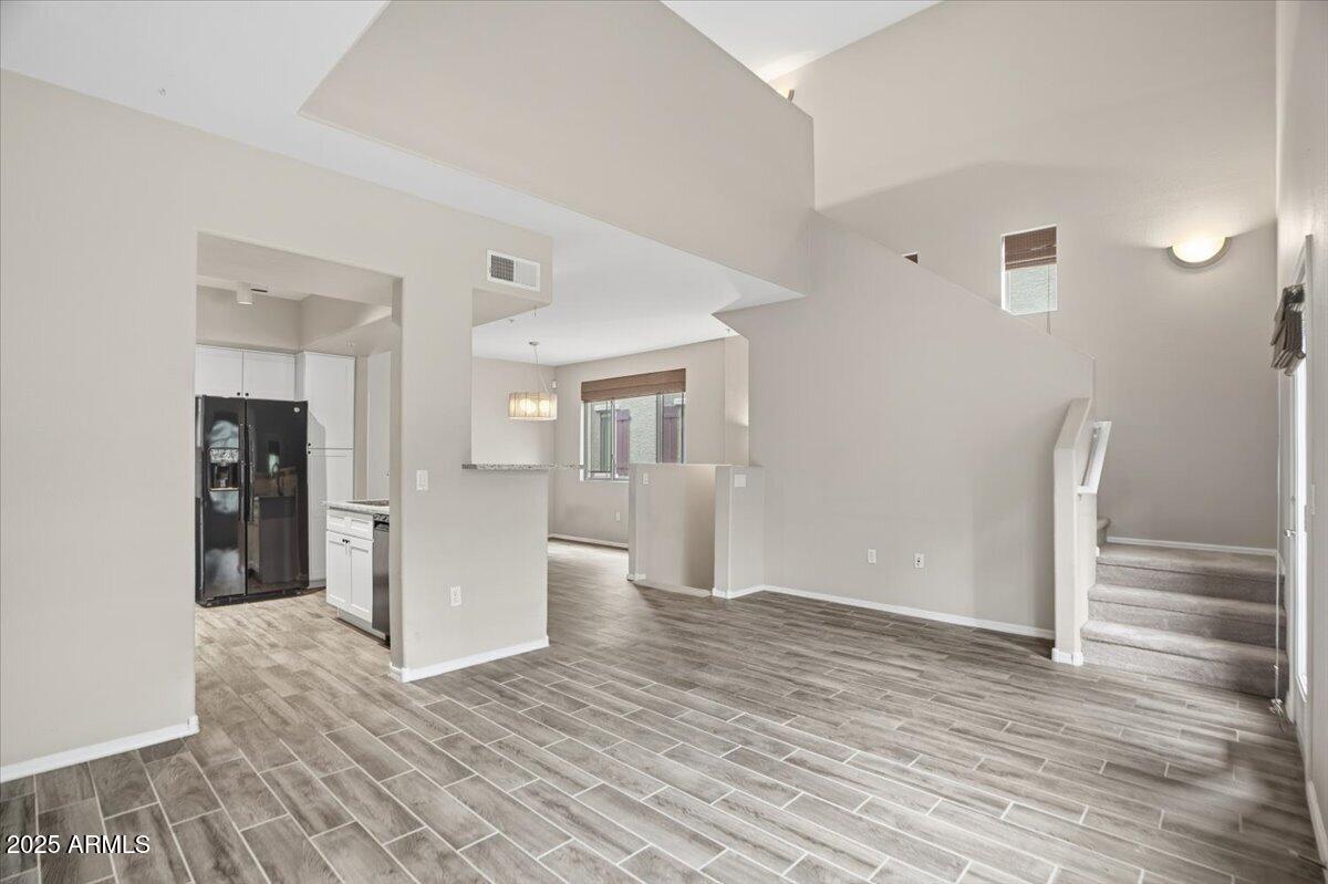 2401 East Rio Salado Parkway, Unit 1045 Tempe, AZ 85288 - Photo 11 of 41 a view of an empty room with wooden floor and a cabinet