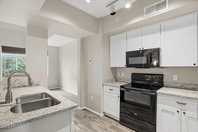 a kitchen with a sink stove and microwave