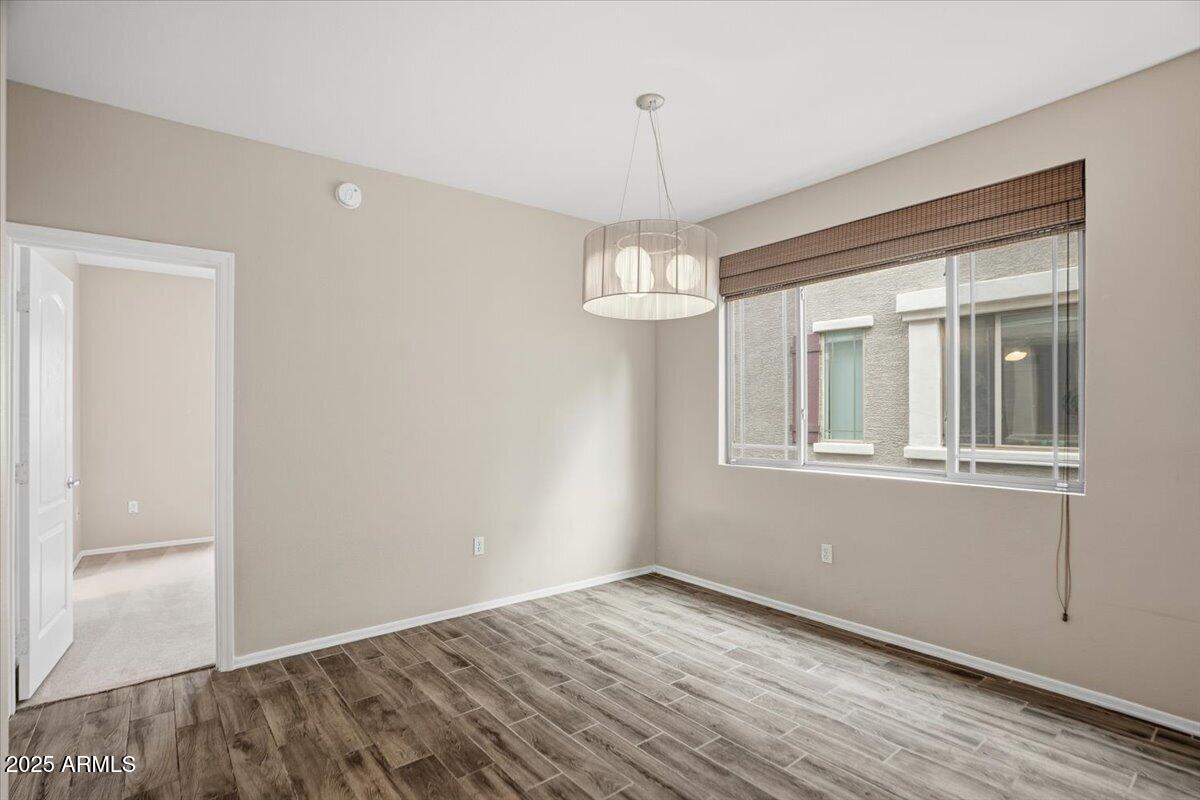 2401 East Rio Salado Parkway, Unit 1045 Tempe, AZ 85288 - Photo 17 of 41 a view of empty room with wooden floor and fan