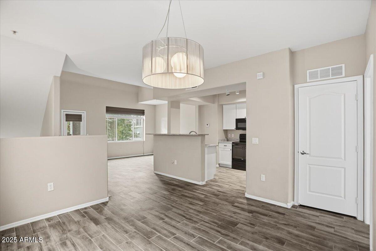 2401 East Rio Salado Parkway, Unit 1045 Tempe, AZ 85288 - Photo 18 of 41 a view of a kitchen with wooden floor and a window