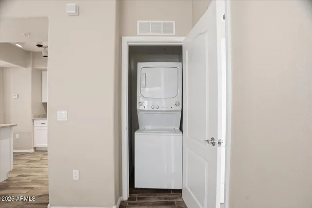 a view of a hallway with a white cabinet and a door