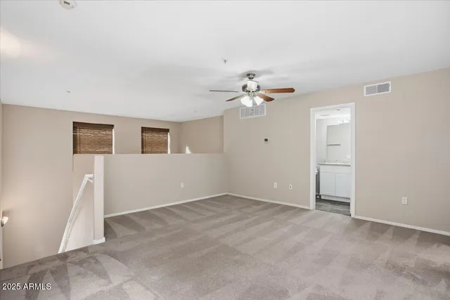 a view of an empty room with a fan