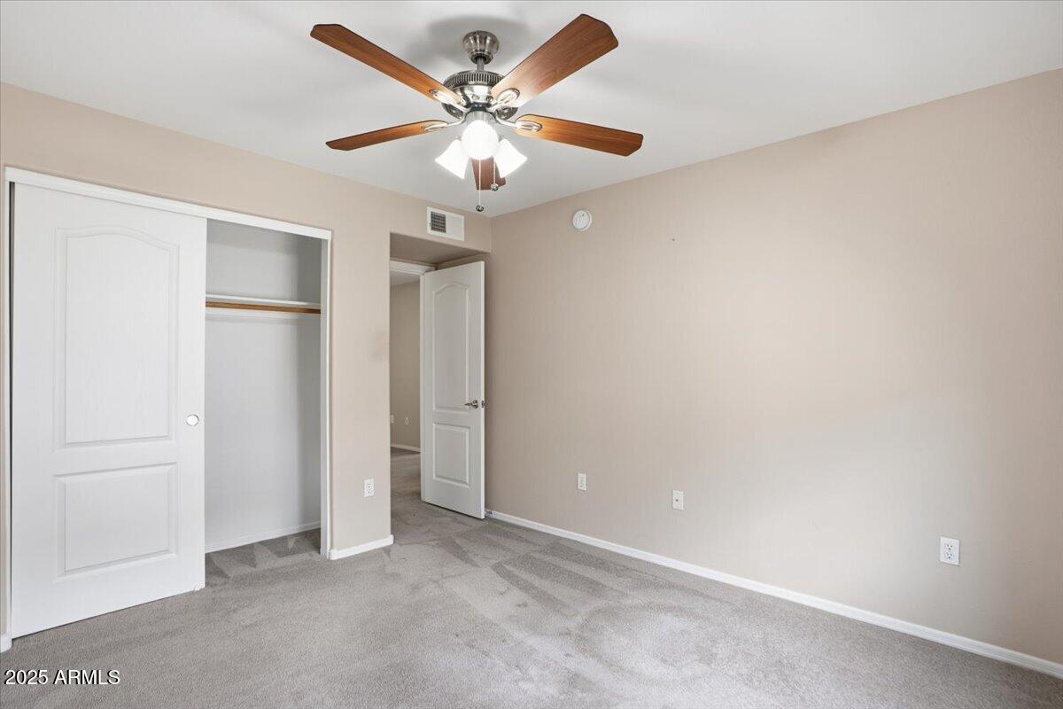 2401 East Rio Salado Parkway, Unit 1045 Tempe, AZ 85288 - Photo 31 of 41 an empty room with a ceiling fan and a window