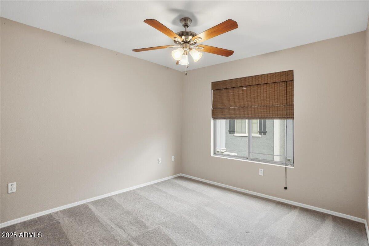 2401 East Rio Salado Parkway, Unit 1045 Tempe, AZ 85288 - Photo 32 of 41 an empty room with a window and a ceiling fan
