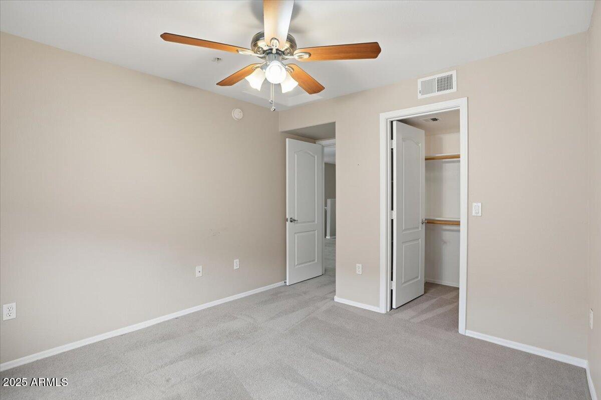 2401 East Rio Salado Parkway, Unit 1045 Tempe, AZ 85288 - Photo 33 of 41 an empty room with closet and a chandelier fan