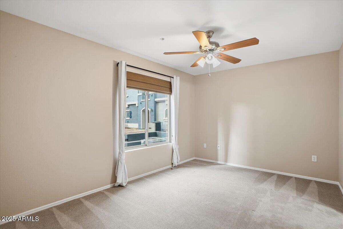 2401 East Rio Salado Parkway, Unit 1045 Tempe, AZ 85288 - Photo 6 of 41 an empty room with chandelier fan