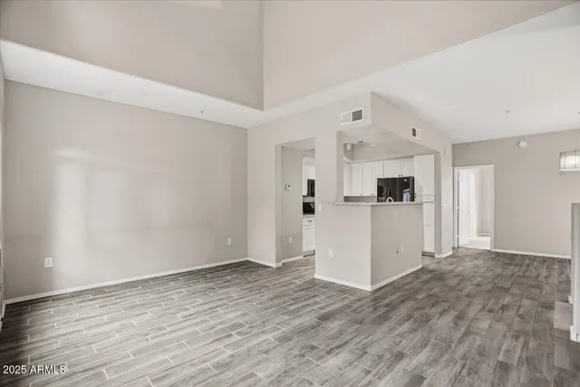 a view of a kitchen with wooden floor and white appliances