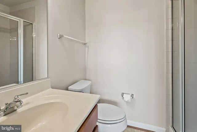 a bathroom with a toilet a sink and a mirror