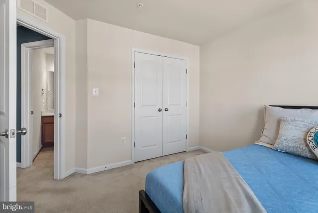 a bedroom with a bed and a view of bathroom