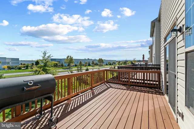 a view of balcony with wooden floor and outdoor seating