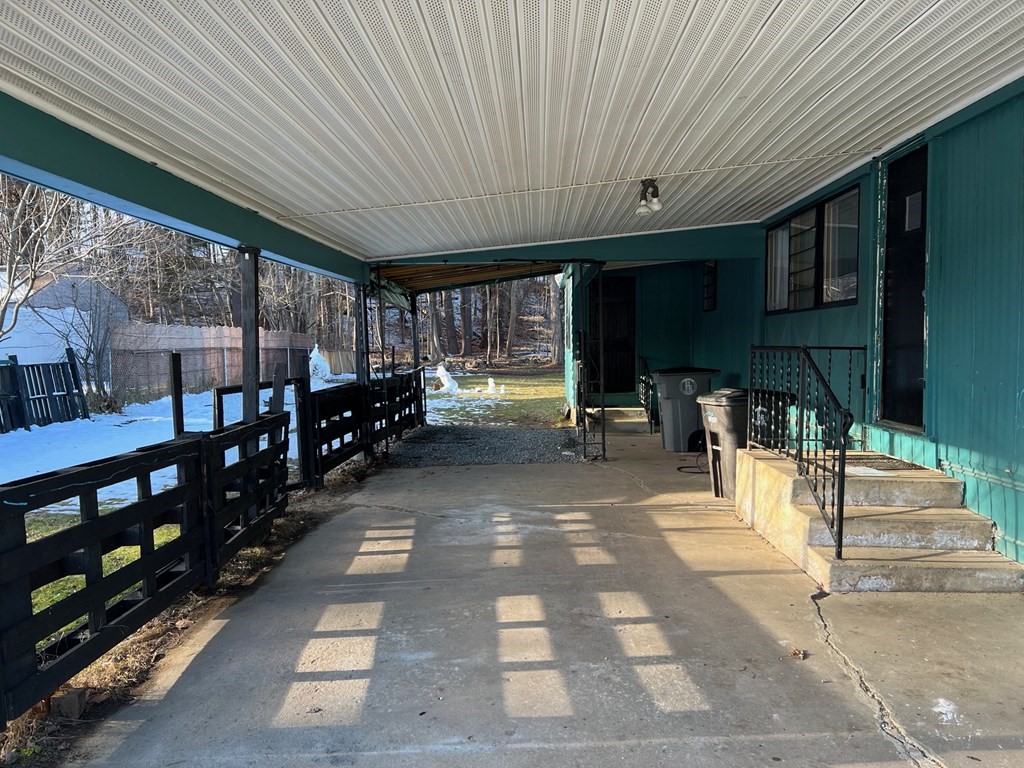 40 Acadia Road Gardner, MA 01440 - Photo 4 of 11 a view of a patio with table and chairs under an umbrella