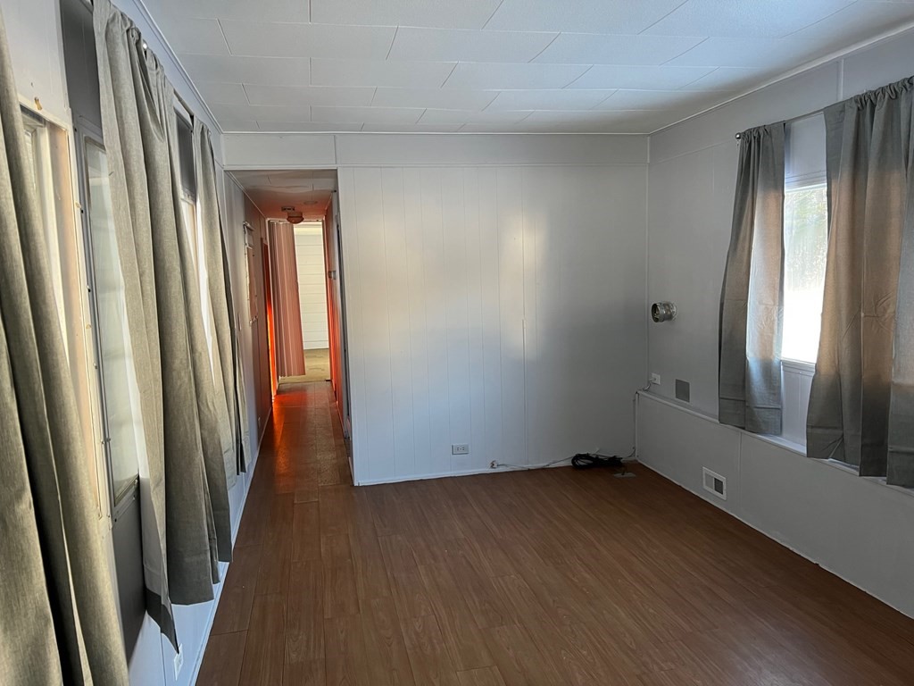 40 Acadia Road Gardner, MA 01440 - Photo 7 of 11 an empty room with wooden floor and windows
