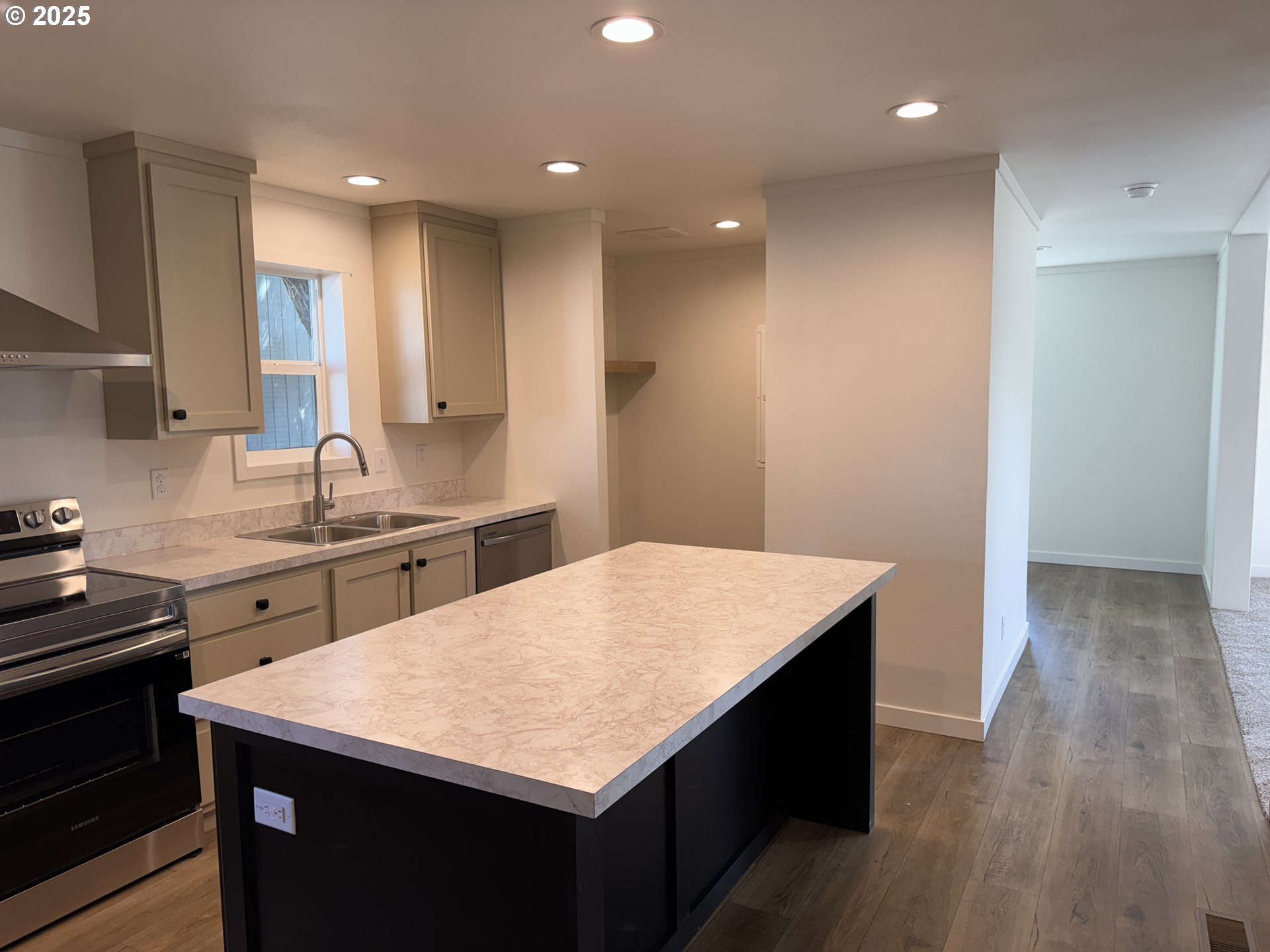 527 West Main Street Goldendale, WA 98620 - Photo 11 of 29 a kitchen with a wooden floor cabinets counter space and sink