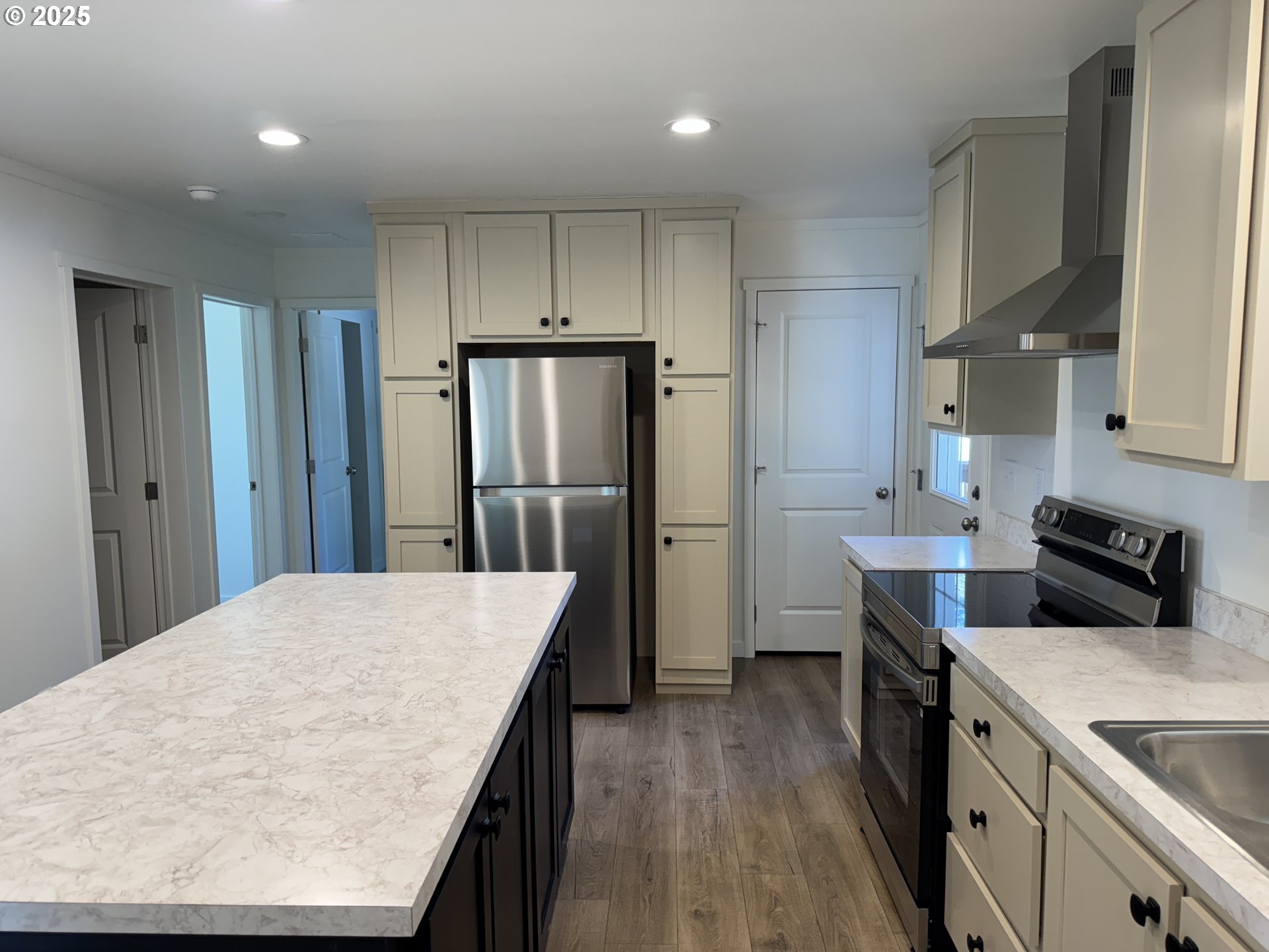 527 West Main Street Goldendale, WA 98620 - Photo 17 of 29 a kitchen with refrigerator cabinets and wooden floor