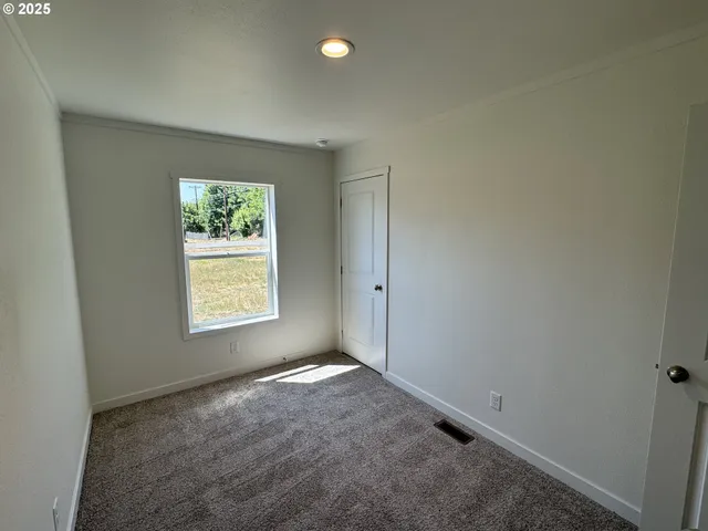 a view of a hallway with wooden shelves