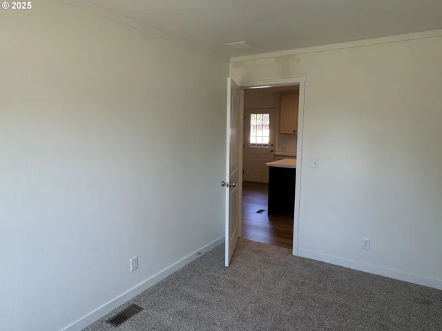a view of a kitchen from the hallway