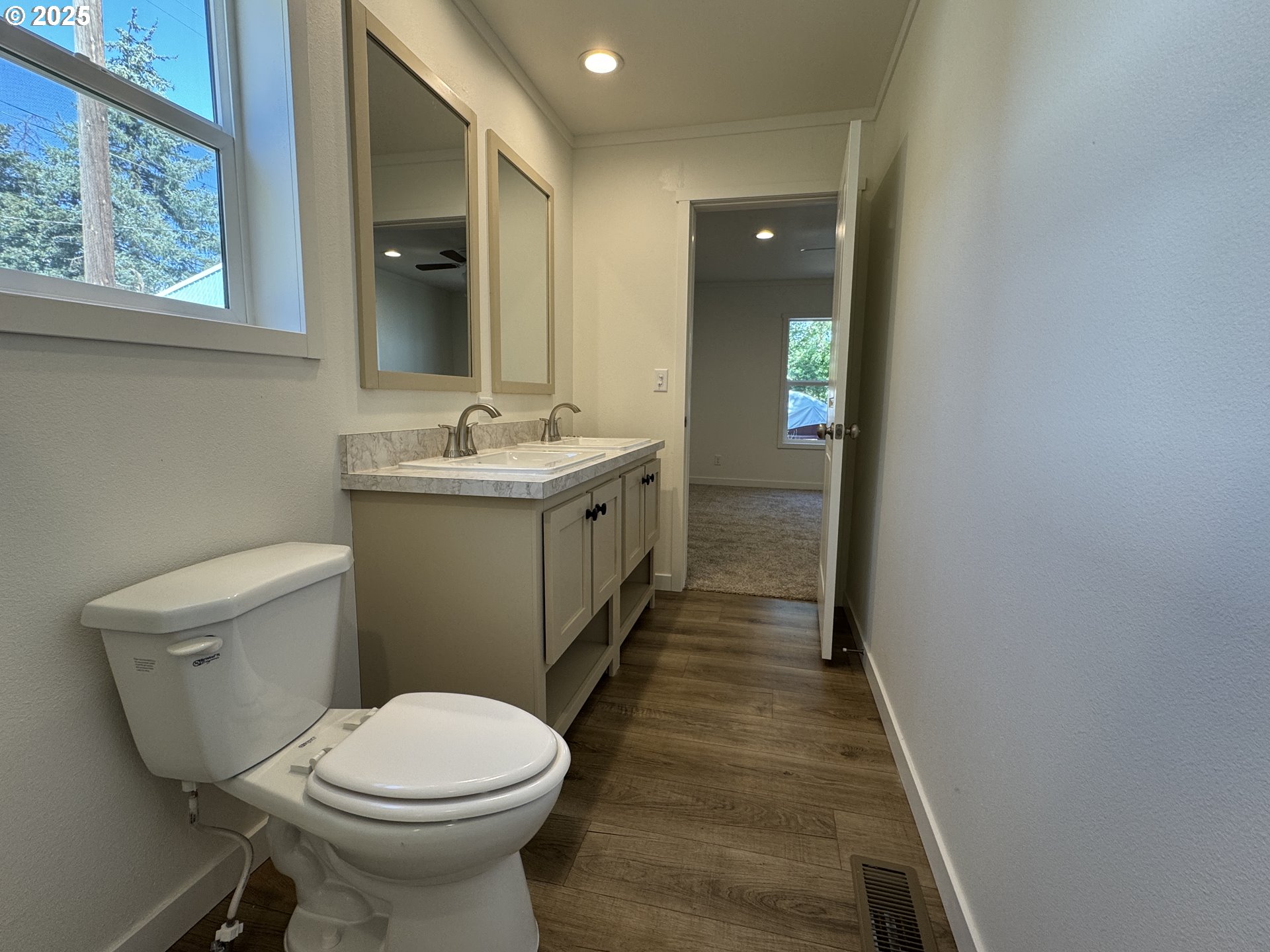 527 West Main Street Goldendale, WA 98620 - Photo 29 of 29 a bathroom with a granite countertop toilet a sink and mirror