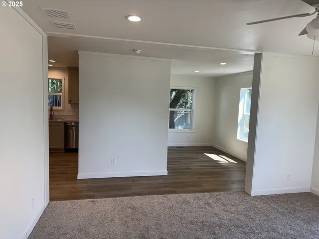 an empty room with windows and entrance