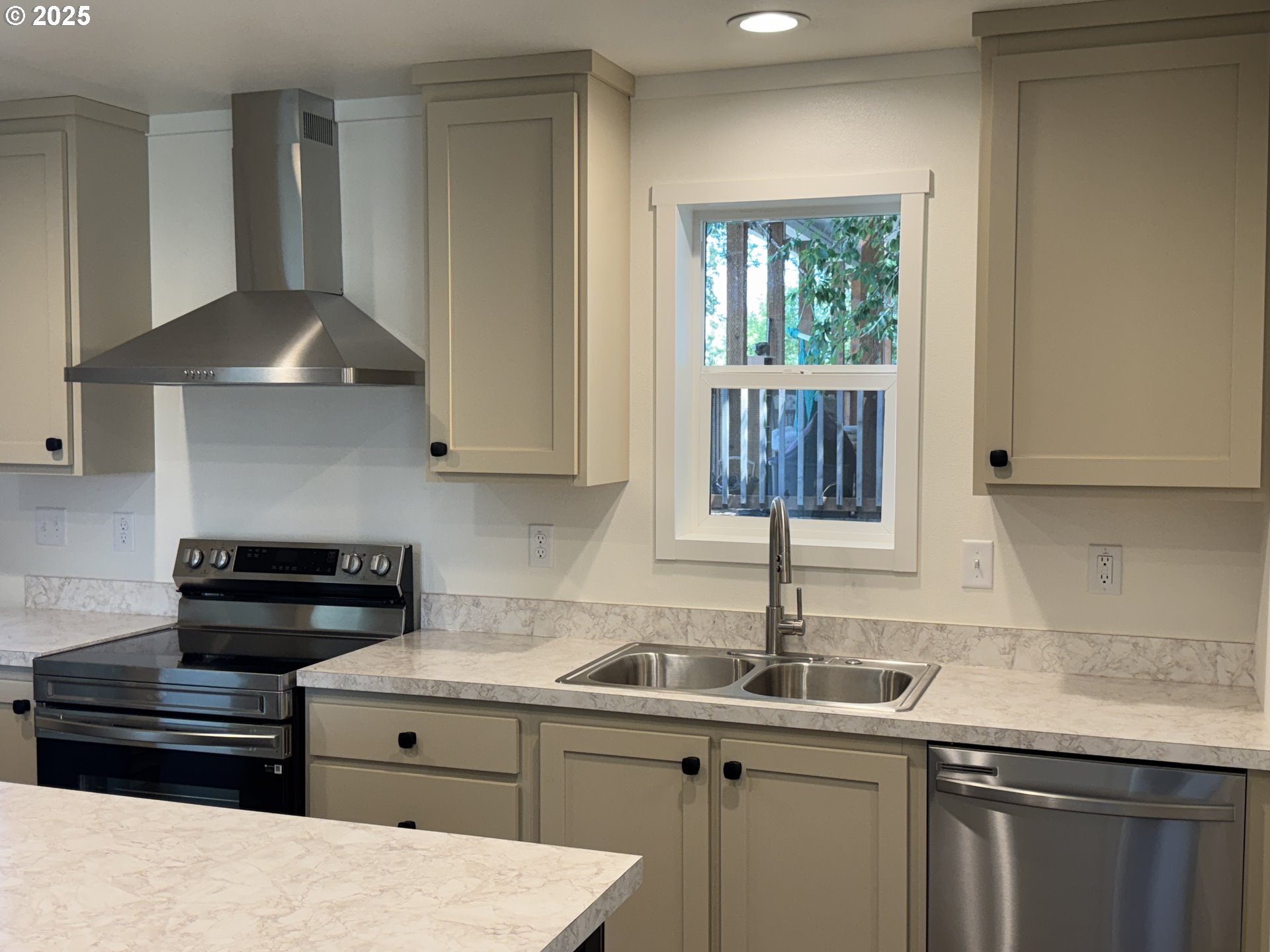 527 West Main Street Goldendale, WA 98620 - Photo 10 of 29 a kitchen with stainless steel appliances granite countertop a sink a stove and a microwave