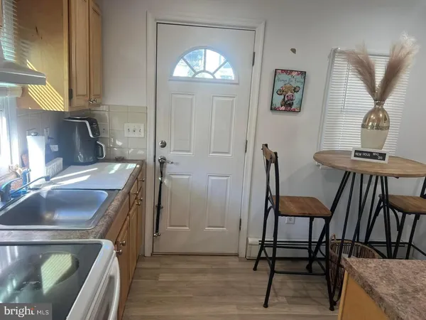 a kitchen that has a microwave a sink and a stove in it