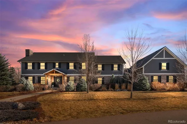 a front view of a house with yard and parking