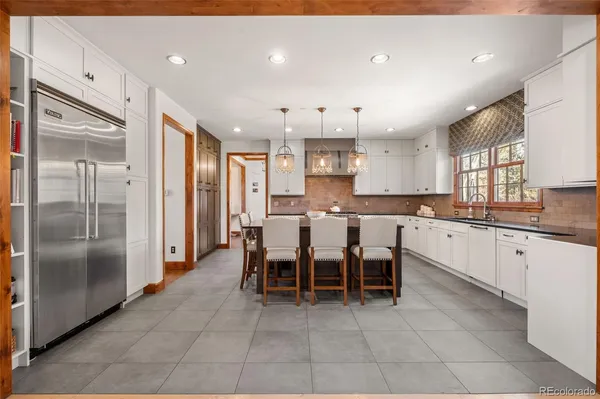 a kitchen with a table chairs stove and cabinets