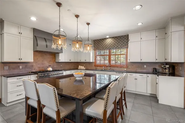 a kitchen with stainless steel appliances granite countertop a sink and a refrigerator