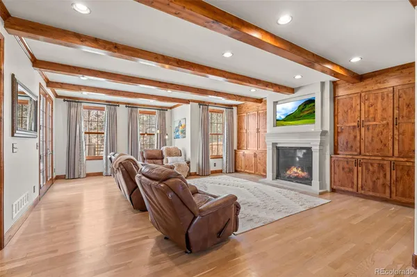 a living room with furniture a rug and a window