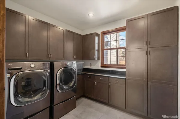 a kitchen with stainless steel appliances granite countertop a refrigerator a oven a sink and a stove