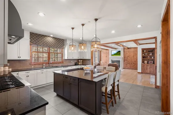 a large kitchen with stainless steel appliances lots of white cabinets