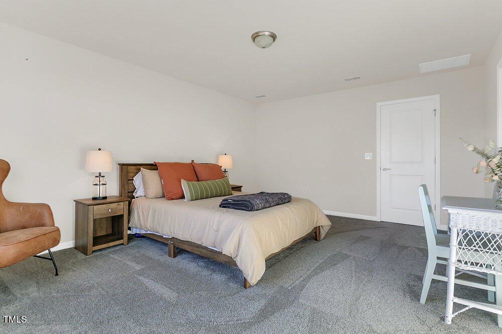3512 Dragonfly River Raleigh, NC 27604 - Photo 15 of 37 a bedroom with a bed and chair