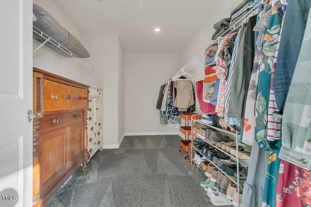 3512 Dragonfly River Raleigh, NC 27604 - Photo 17 of 37 a view of walk in closet with clothes and shoes