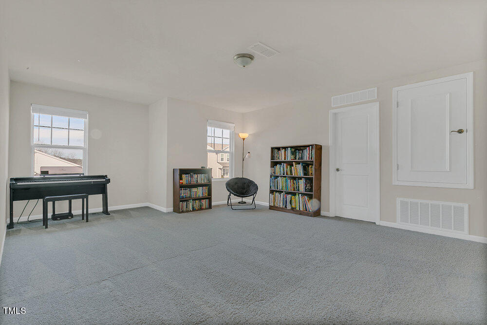3512 Dragonfly River Raleigh, NC 27604 - Photo 19 of 37 a view of an empty room with window and a kitchen